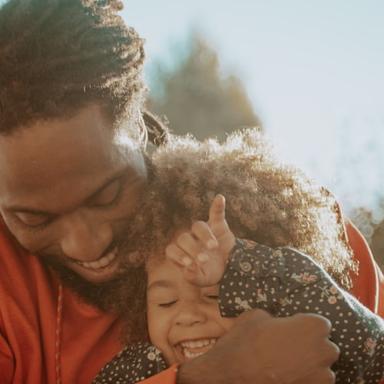 Father laughing with his young daughter